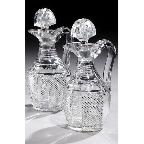 A PAIR OF VICTORIAN SILVER MOUNTED CUT GLASS CLARET JUGS